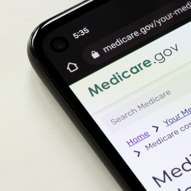 A phone screen displays the Medicare site — insurance coverage from STAT