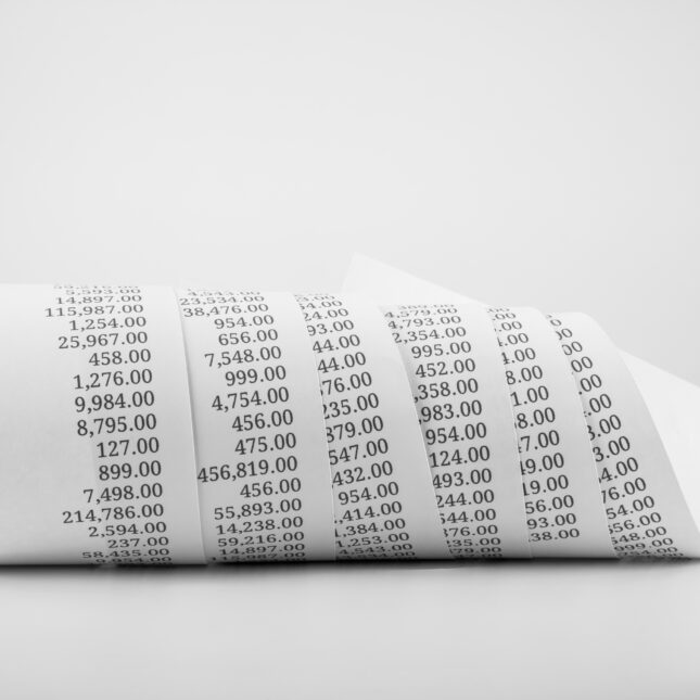 Black and white photo of a receipt rolled up. -- health policy coverage from STAT