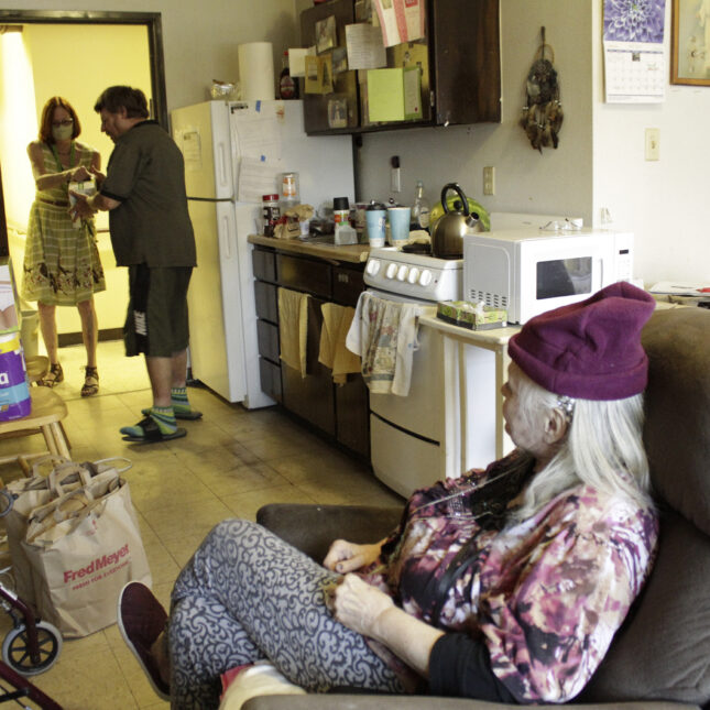 File news photo of Joel Aslin accepts groceries for his neighbor, Karen Colby, from a volunteer with the nonprofit Store to Door on July 22, 2021, in Portland, Ore. Colby spent 10 days in the hospital with complications from heat stroke after nearly dying during a record-smashing heat wave that hit the Pacific Northwest with temperatures of up to 116 F. As heat waves fueled by climate change arrive earlier, grow more intense and last longer, people over 60 who are more vulnerable to high temperatures are increasingly at risk of dying from heat-related causes.