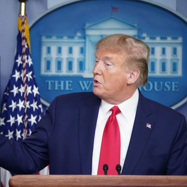 US President Donald Trump holds up a paper displaying a news story about ventilators during the daily briefing on the novel coronavirus, in April 2020. -- first opinion coverage from STAT