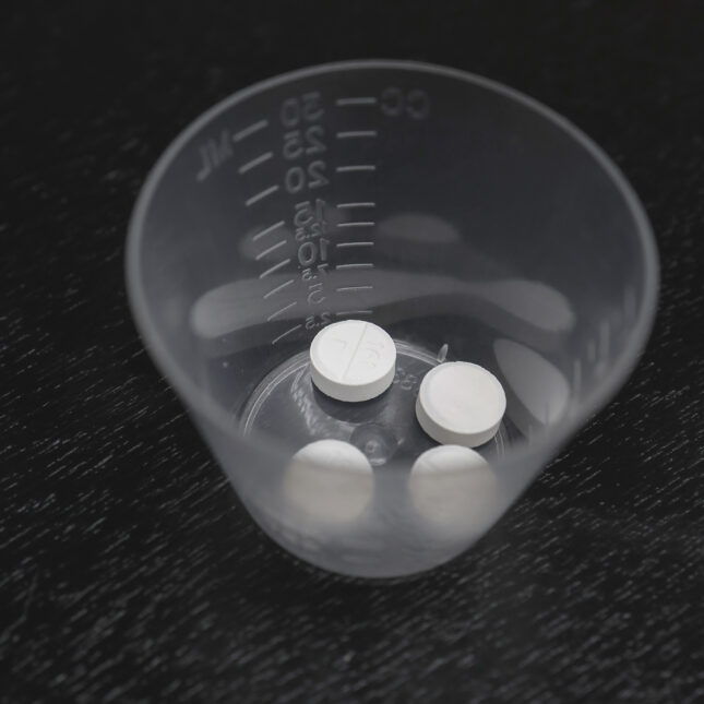 In this photo illustration, Misoprostol tablets are displayed in a medicine cup against a black background. -- first opinion coverage from STAT