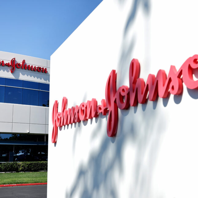 A Johnson & Johnson sign with the company's red logo in front of its building, which also displays the red logo — first opinion coverage from STAT