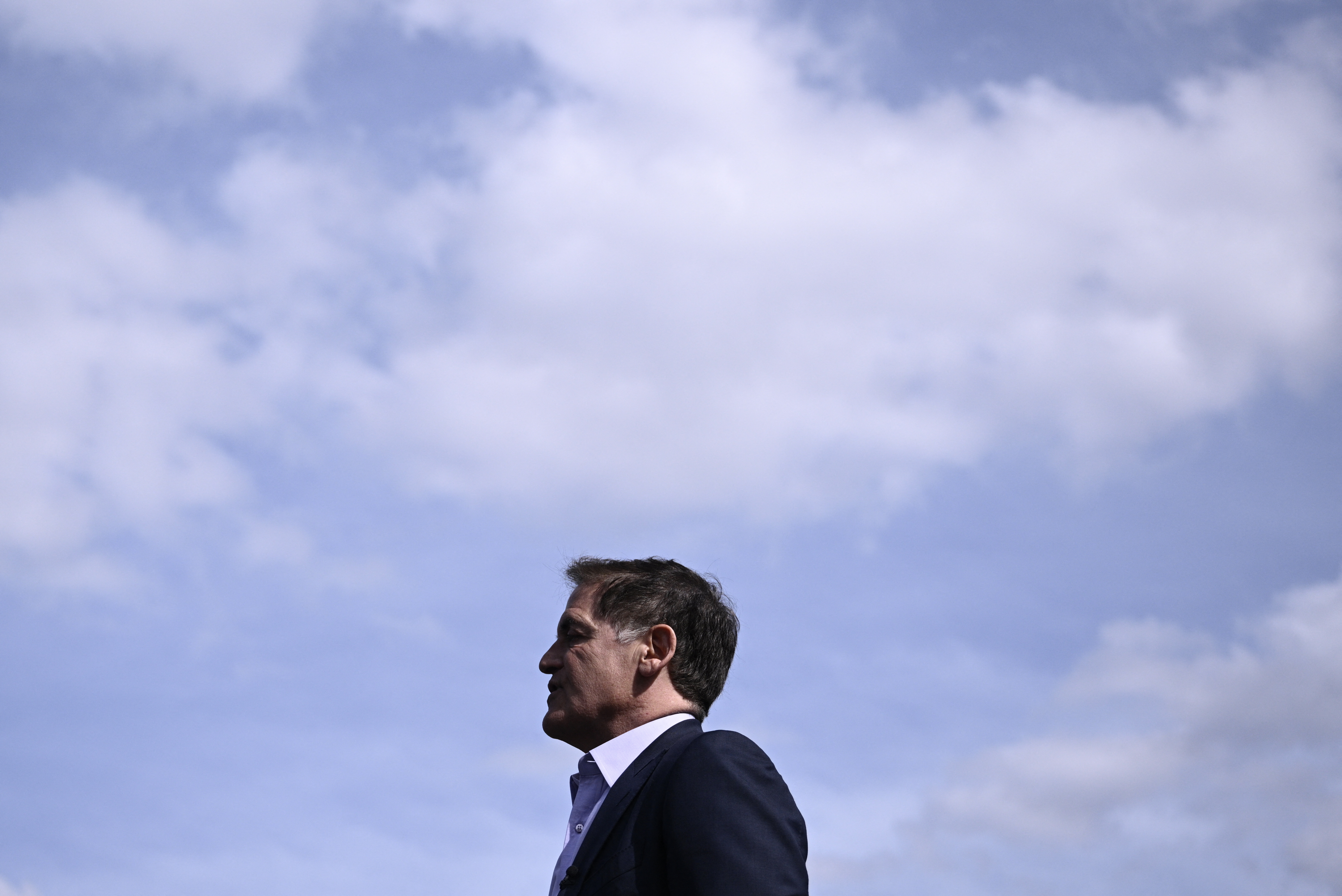 Profile portrait of Mark Cuban with the clouds and sky behind him. -- coverage from STAT