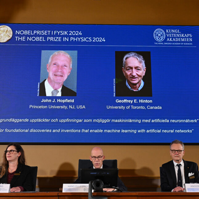 A screen shows the laureates of the 2024 Nobel Prize in Physics, US physicist John J Hopfield (L) and Canadian-British computer scientist and cognitive psychologist Geoffrey E Hinton, during the announcement at the Royal Swedish Academy of Sciences in Stockholm, Sweden on October 8, 2024.